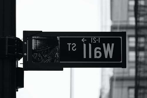 new york grayscale photo of Wall St. signage money